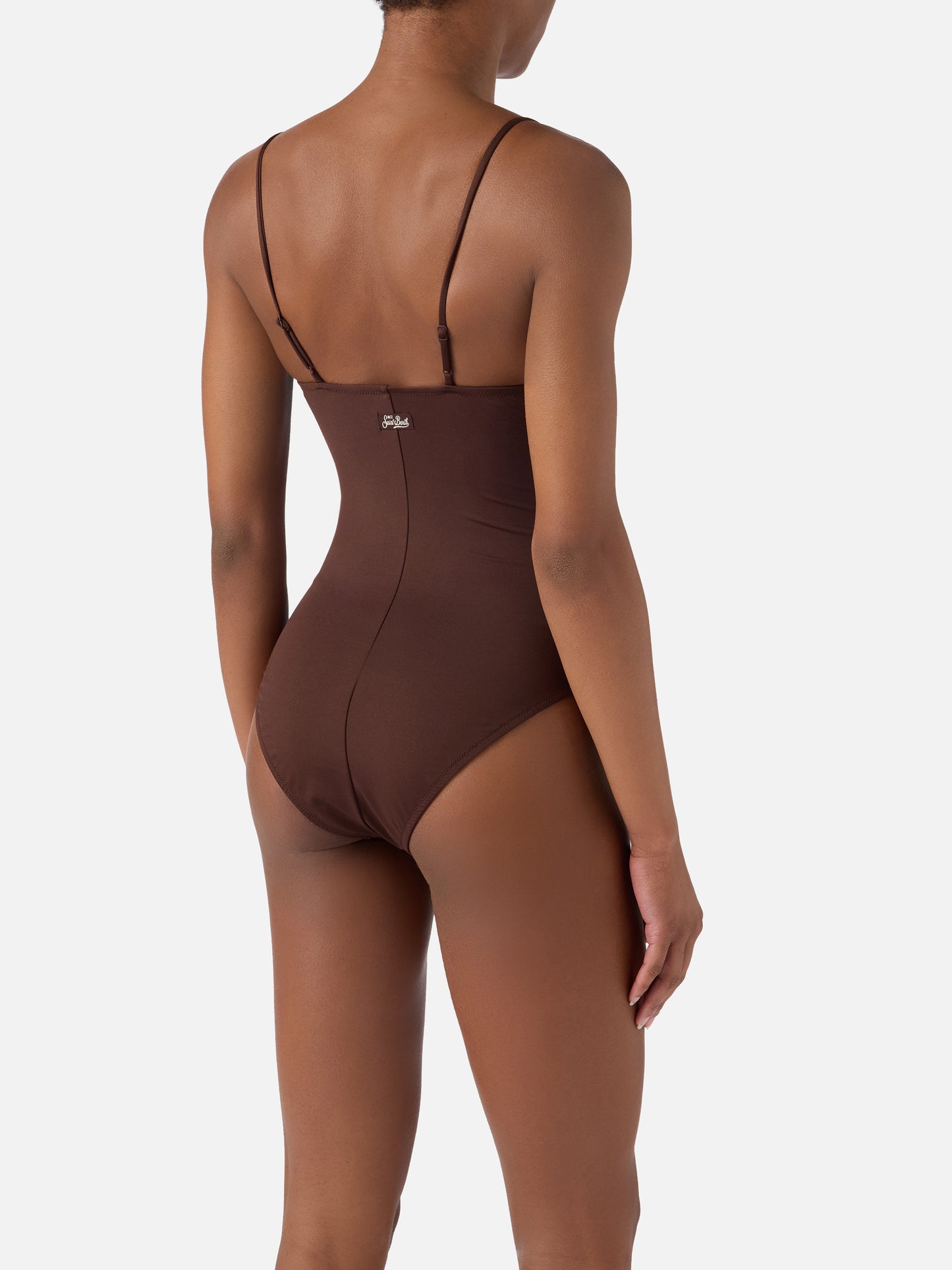 Medea one-piece swimsuit in brown with beaded sea-themed decorations